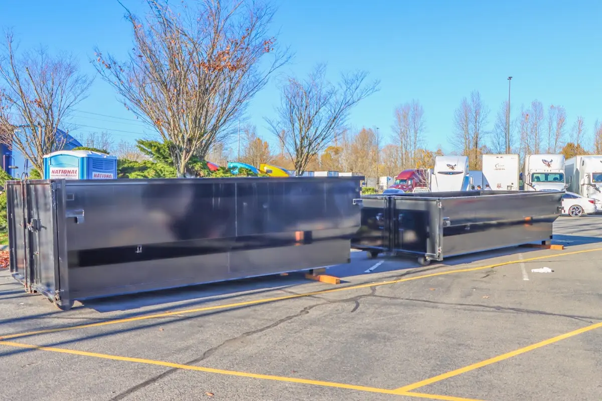 Professional dumpster rental service with roll-off container on residential driveway in Lower Makefield